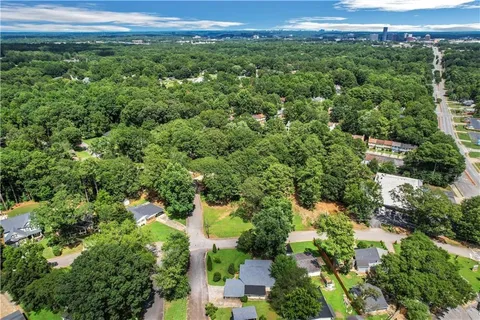 an aerial view of a houses with a yard and lake view