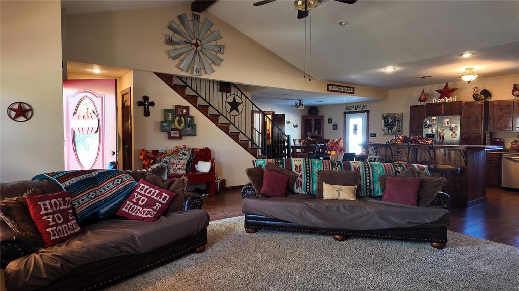 200 County Road 1260 Decatur, TX 76234 - Photo 1 of 1 Living area featuring stairway, dark wood-style flooring, a ceiling fan, high vaulted ceiling, and beam ceiling