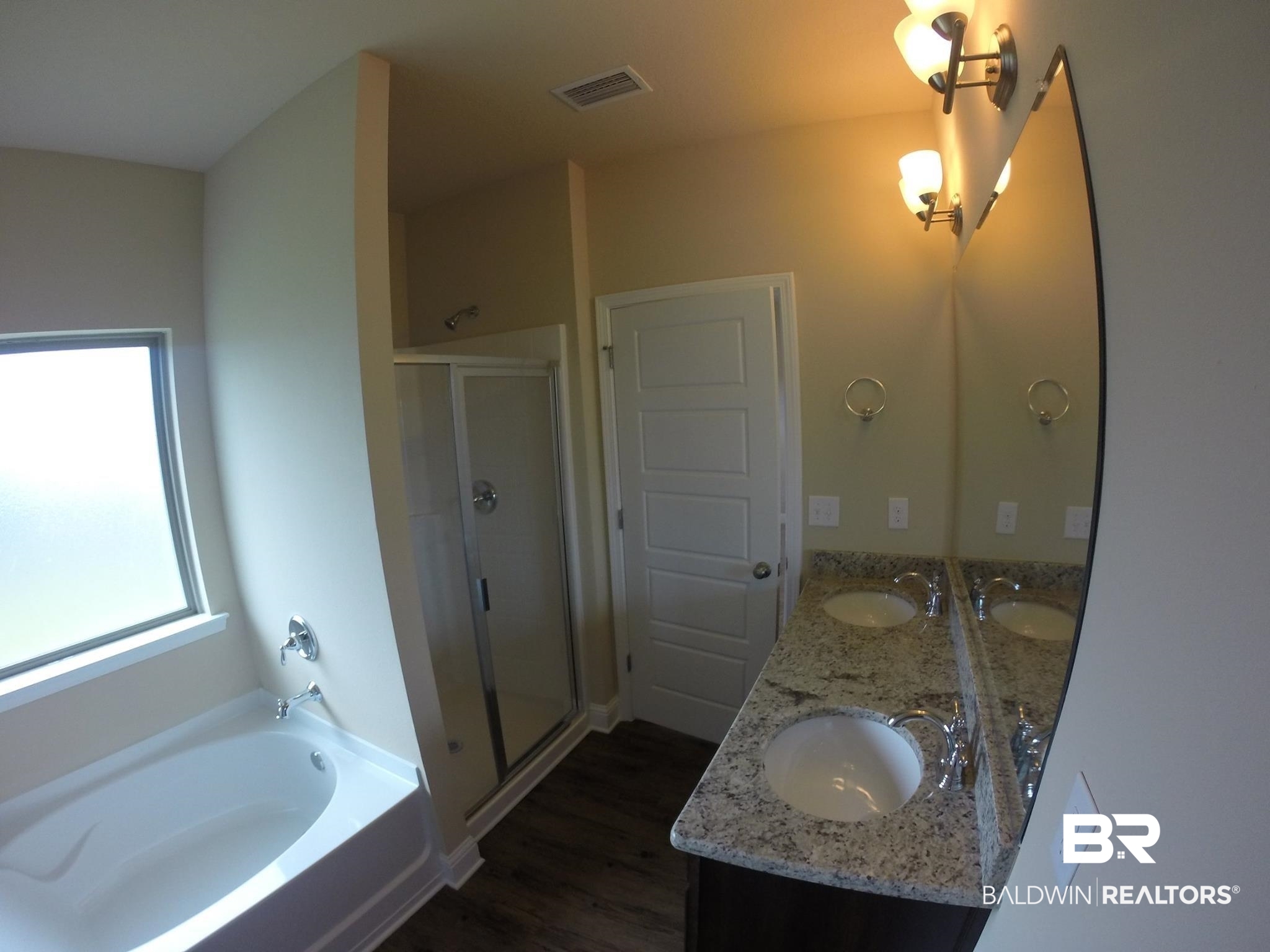 2996 Notsram Court Mobile, AL 36695 - Photo 9 of 16 Full bath featuring double vanity, wood finished floors, a shower stall, and a sink