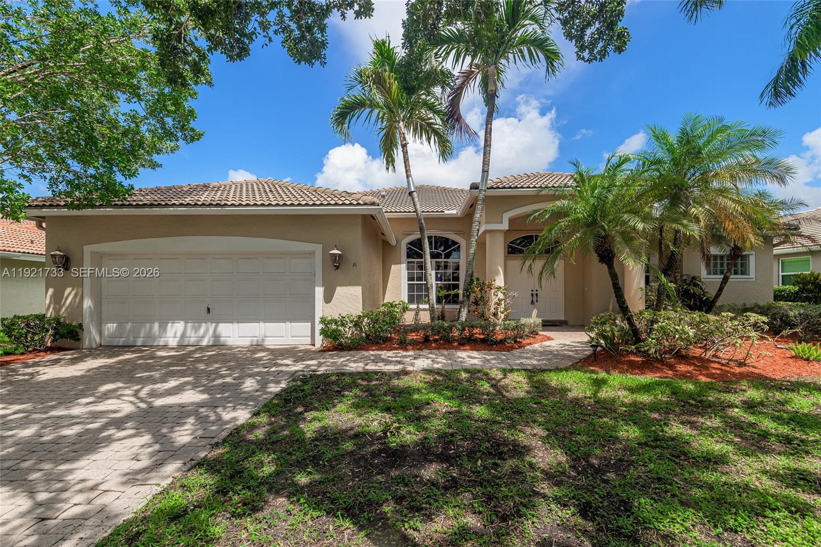 3843 Oak Ridge Circle Weston, FL 33331 - Photo 1 of 39 a front view of a house with yard and trees