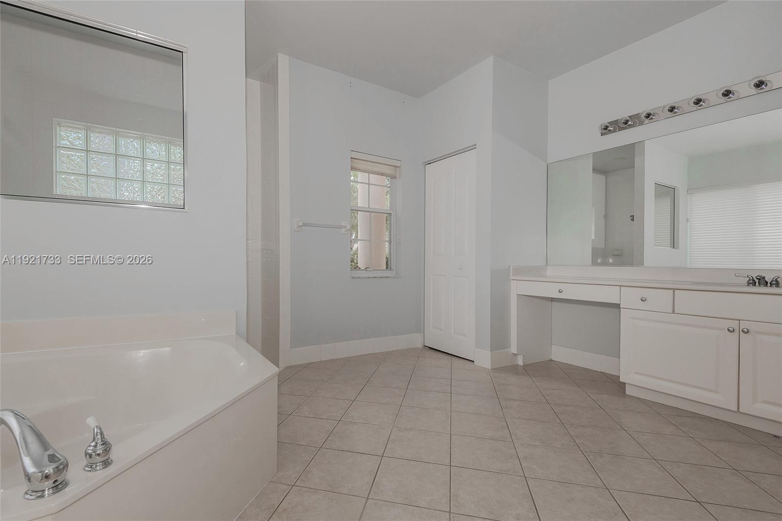 3843 Oak Ridge Circle Weston, FL 33331 - Photo 20 of 39 a bathroom with a bathtub sink and mirror