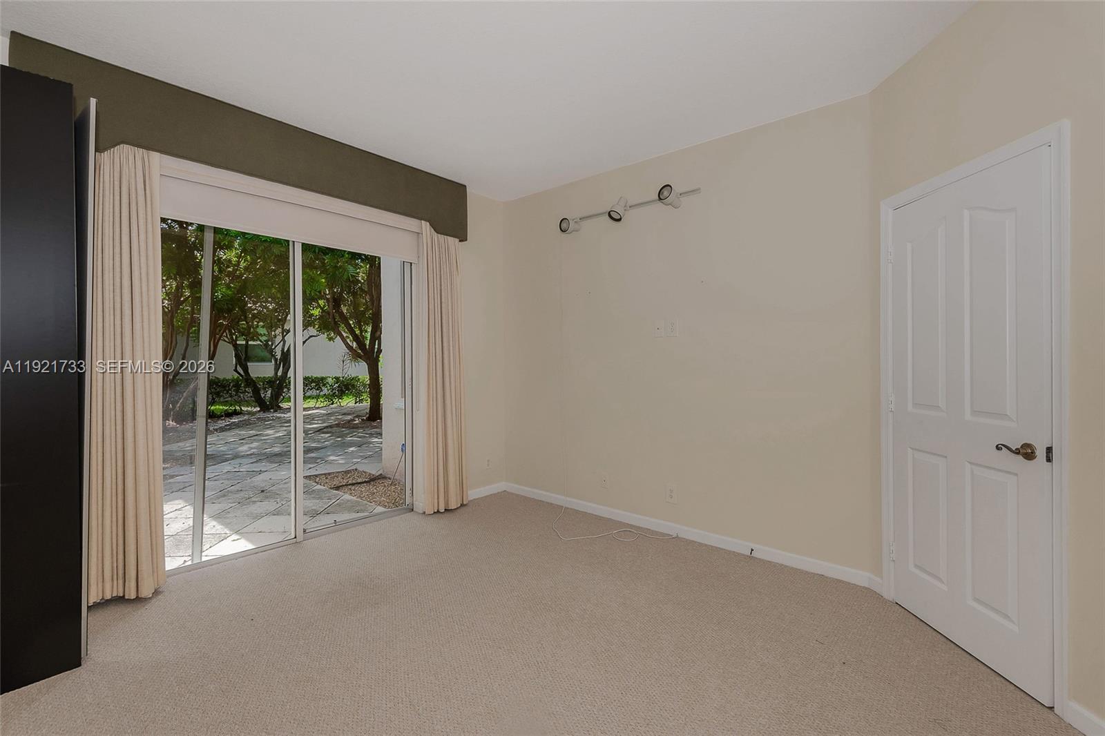 3843 Oak Ridge Circle Weston, FL 33331 - Photo 23 of 39 an empty room with floor to ceiling windows and an outdoor view