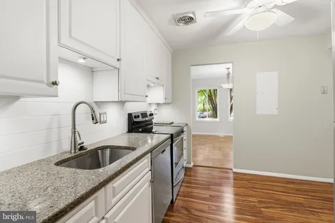 a kitchen with a white cabinets and stainless steel appliances