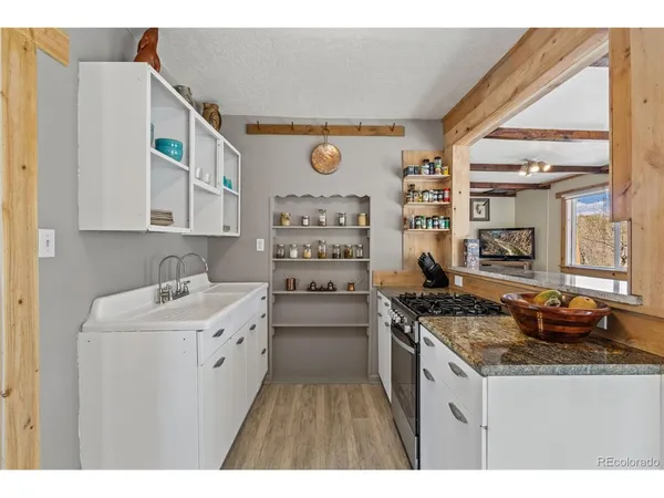 a kitchen with a sink stove and cabinets