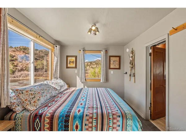 a bedroom with a large bed and a window