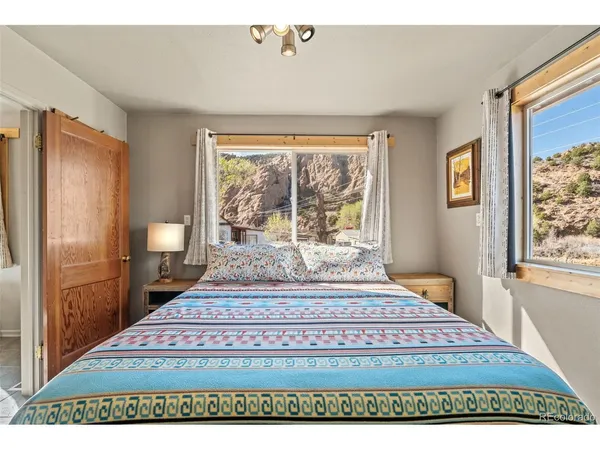 a bedroom with a bed and a large window