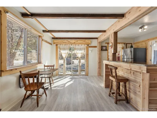 a dining room with furniture and wooden floor