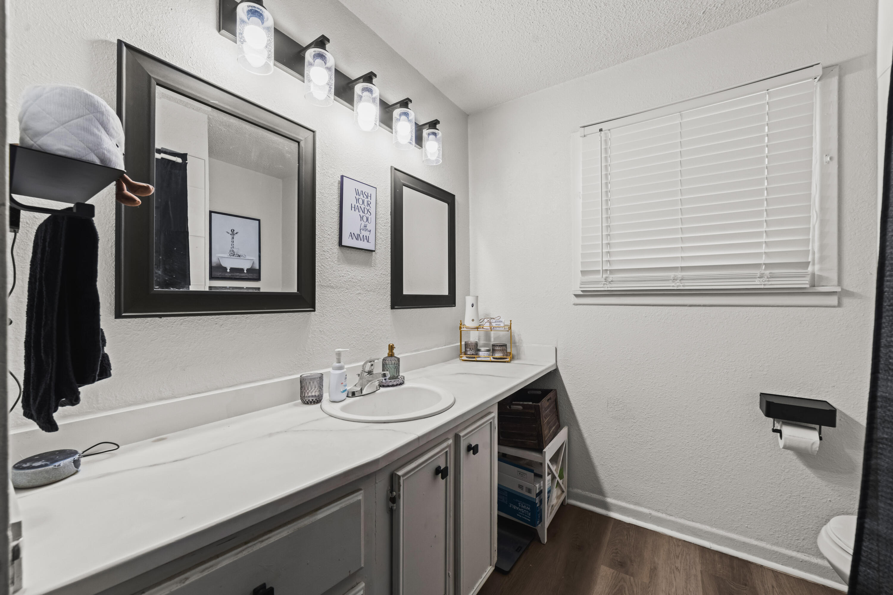 2510 59th Street Lubbock, TX 79413 - Photo 18 of 22 a bathroom with a sink a vanity and a mirror