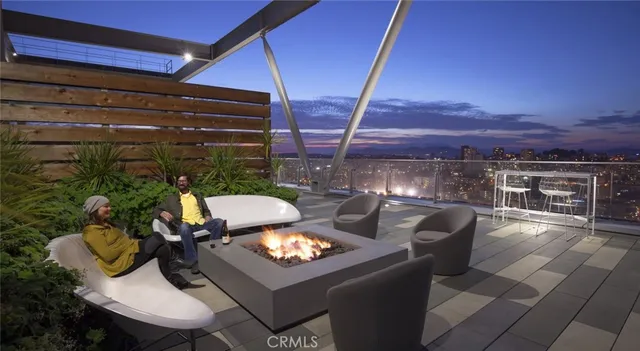 a view of a patio with swimming pool and sitting area