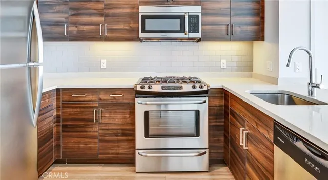 a kitchen with granite countertop a stove top oven microwave and cabinets