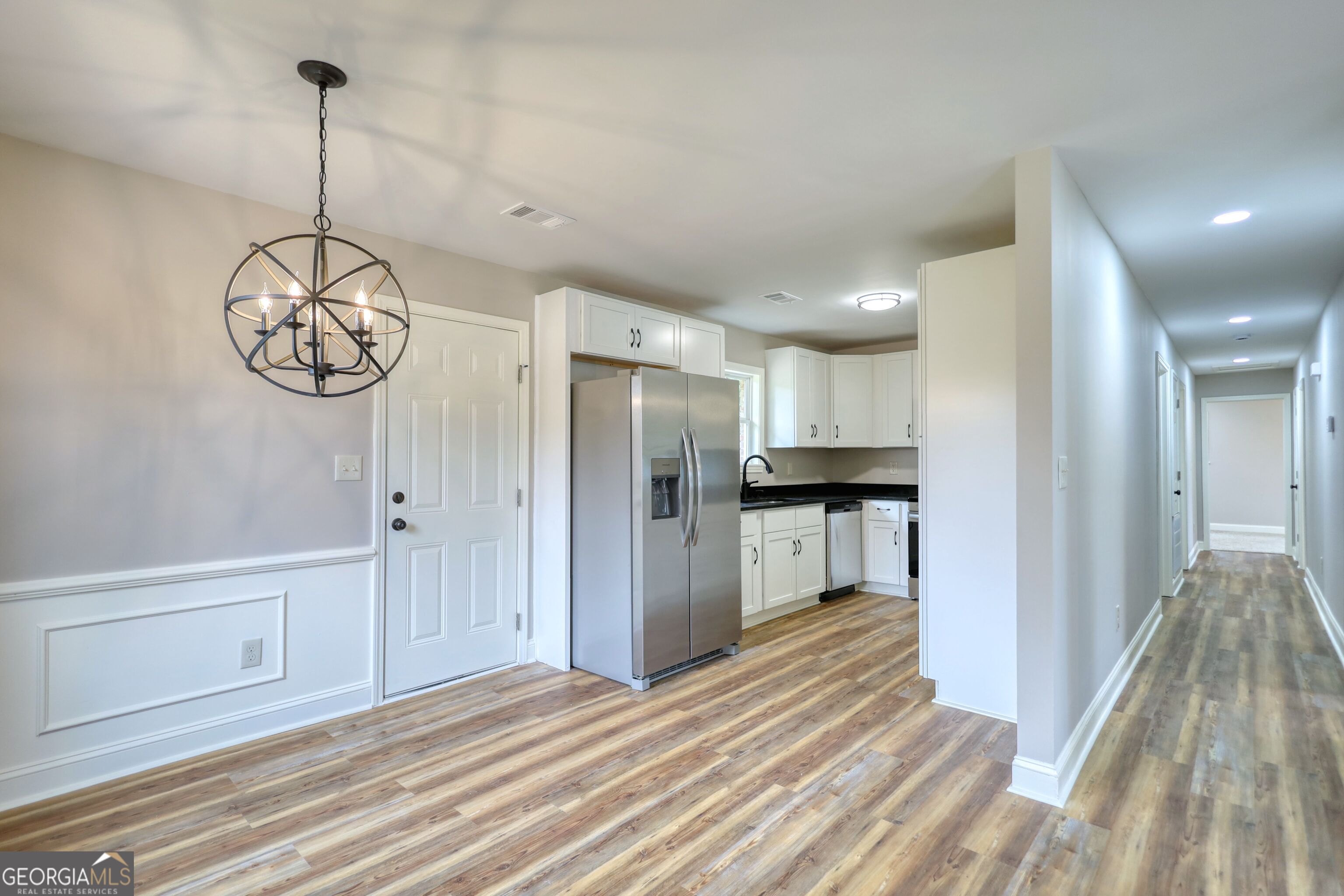 855 Meadow Ridge Drive Madison, GA 30650 - Photo 11 of 41 a view of a room with wooden floor kitchen view and a window