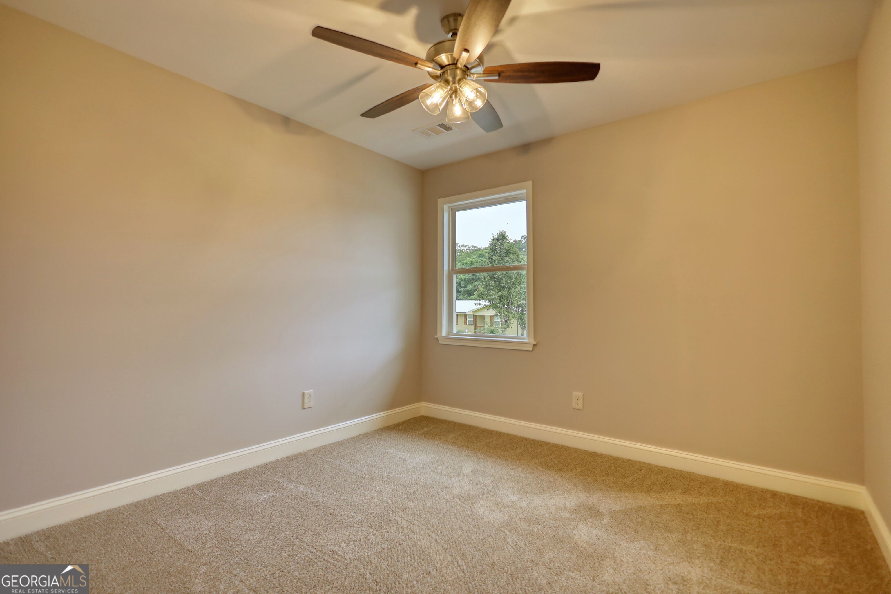 855 Meadow Ridge Drive Madison, GA 30650 - Photo 17 of 41 an empty room with a window and a ceiling fan