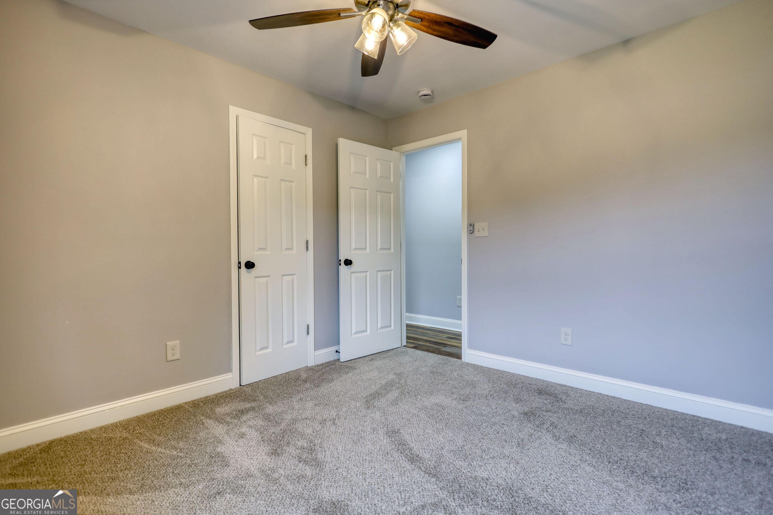 855 Meadow Ridge Drive Madison, GA 30650 - Photo 18 of 41 an empty room with a chandelier fan and windows