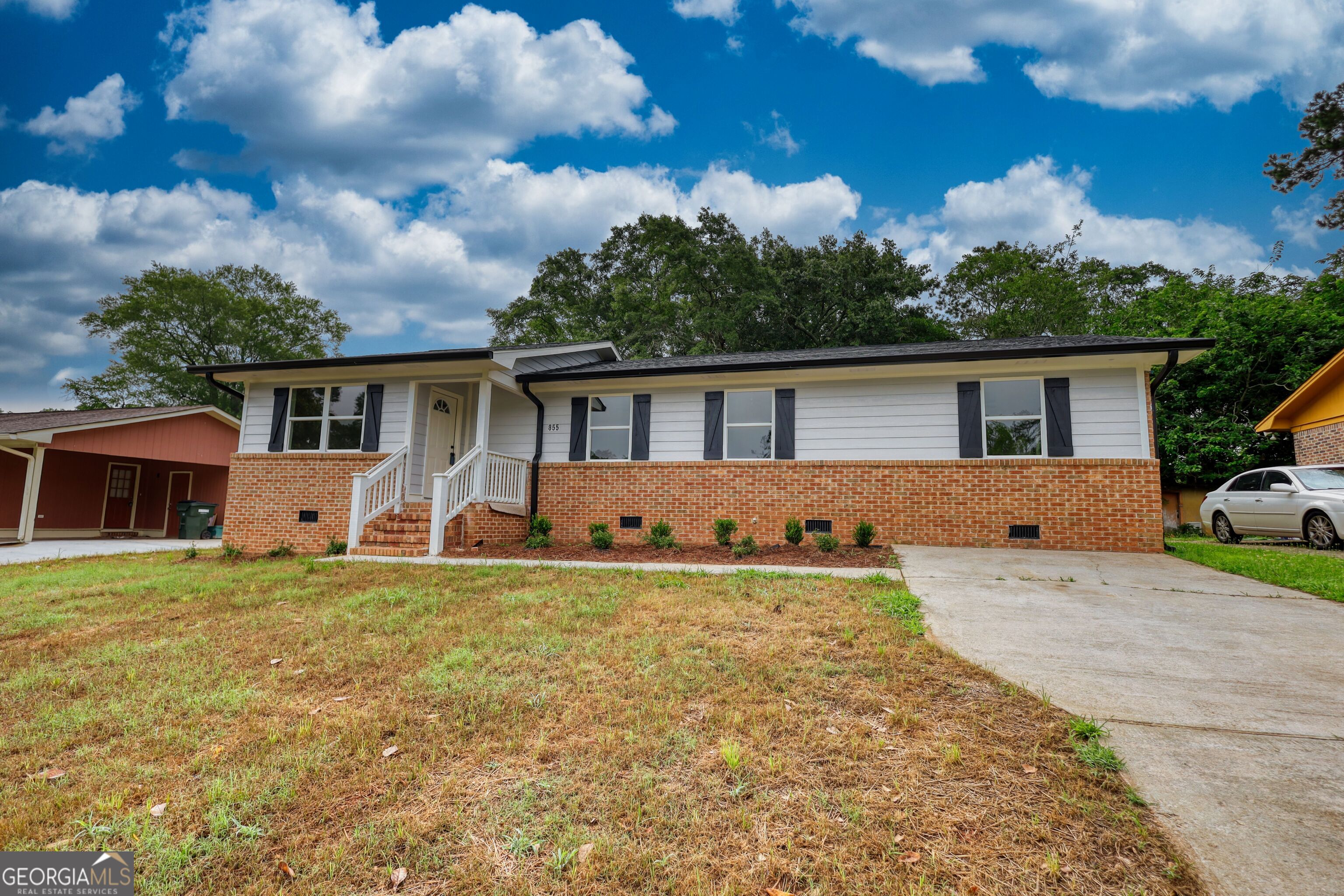 855 Meadow Ridge Drive Madison, GA 30650 - Photo 2 of 41 a front view of house with yard and trees in the background