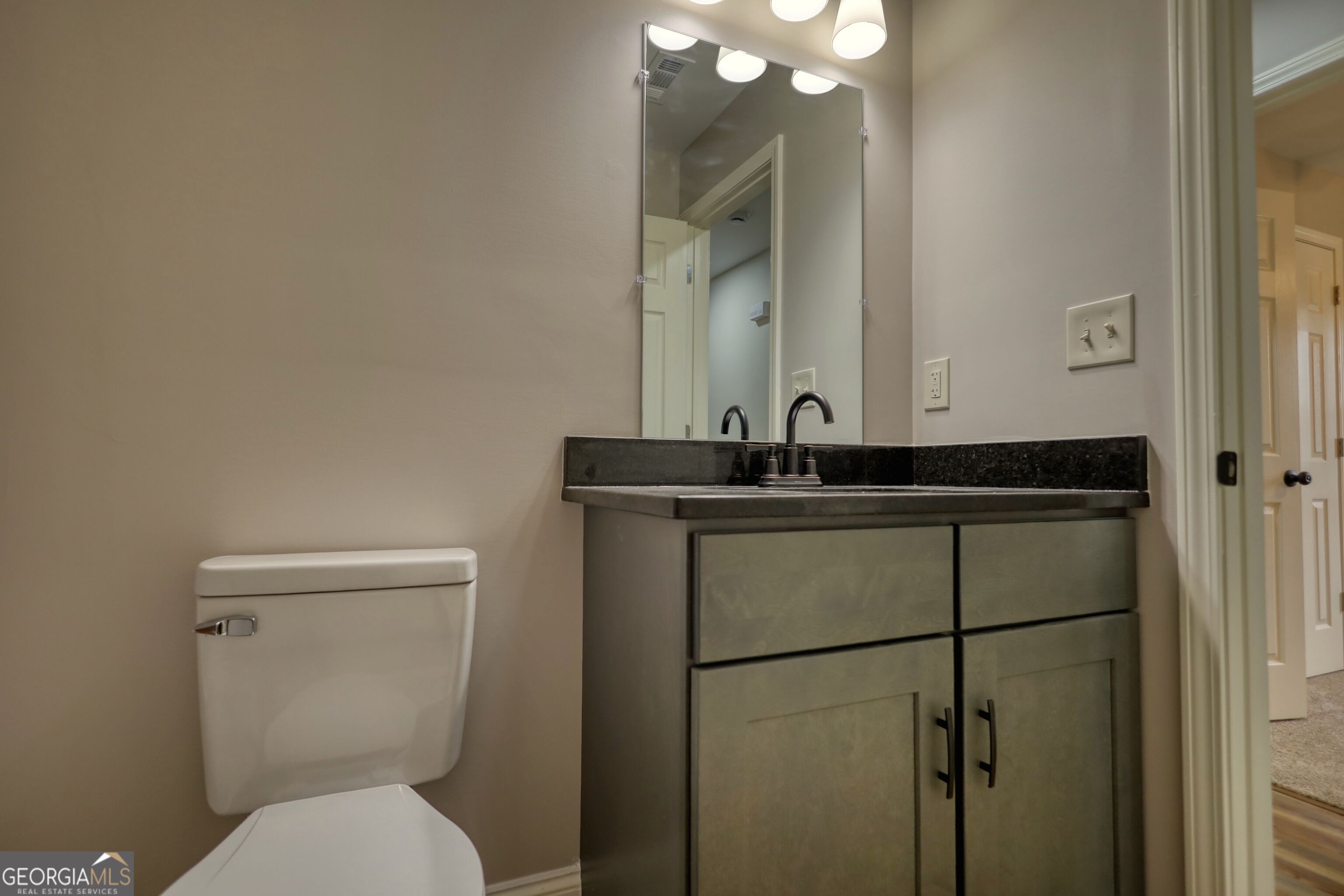 855 Meadow Ridge Drive Madison, GA 30650 - Photo 22 of 41 a bathroom with a sink toilet and mirror