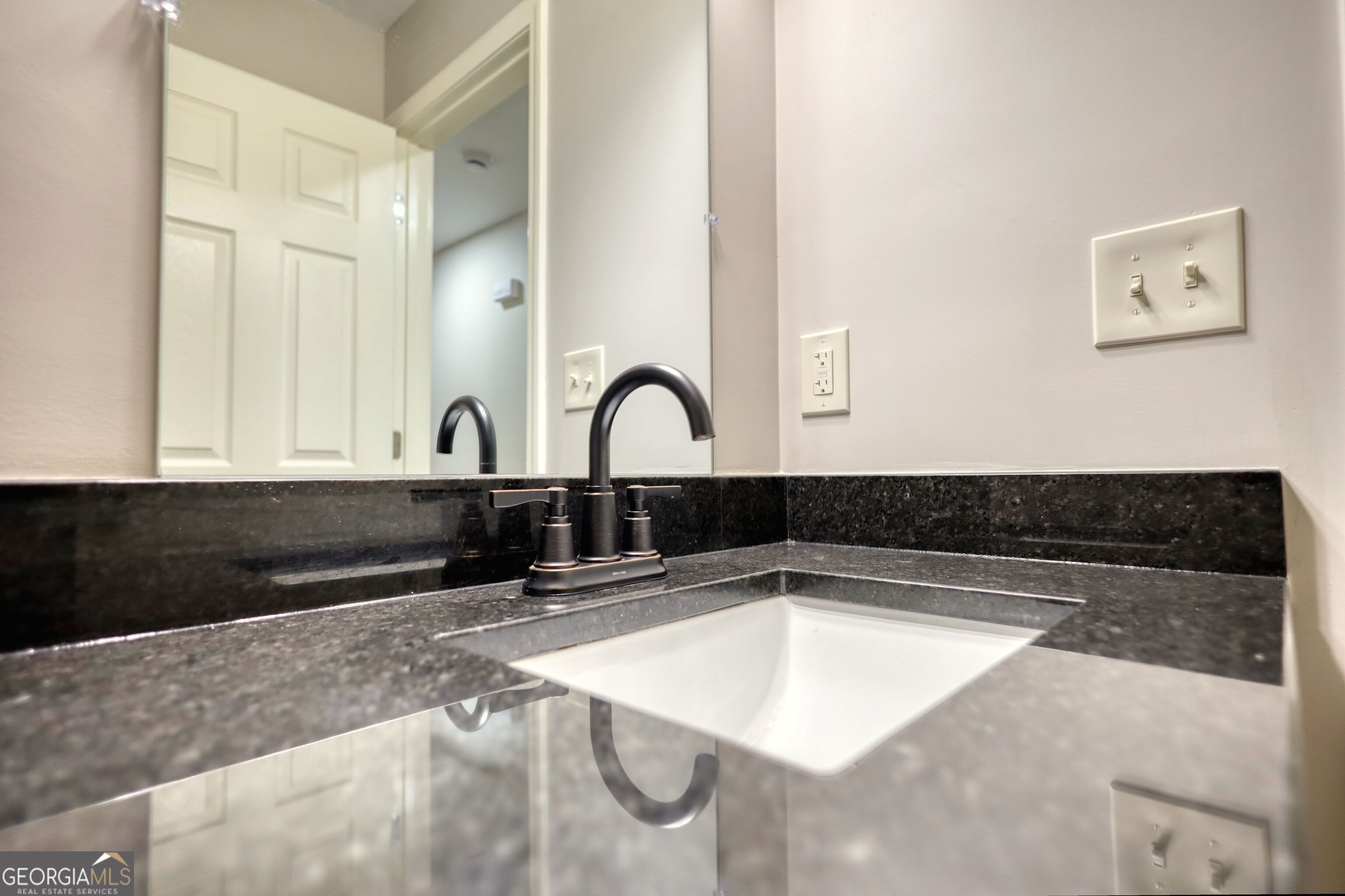 855 Meadow Ridge Drive Madison, GA 30650 - Photo 23 of 41 a kitchen with granite countertop a sink and a stove top oven