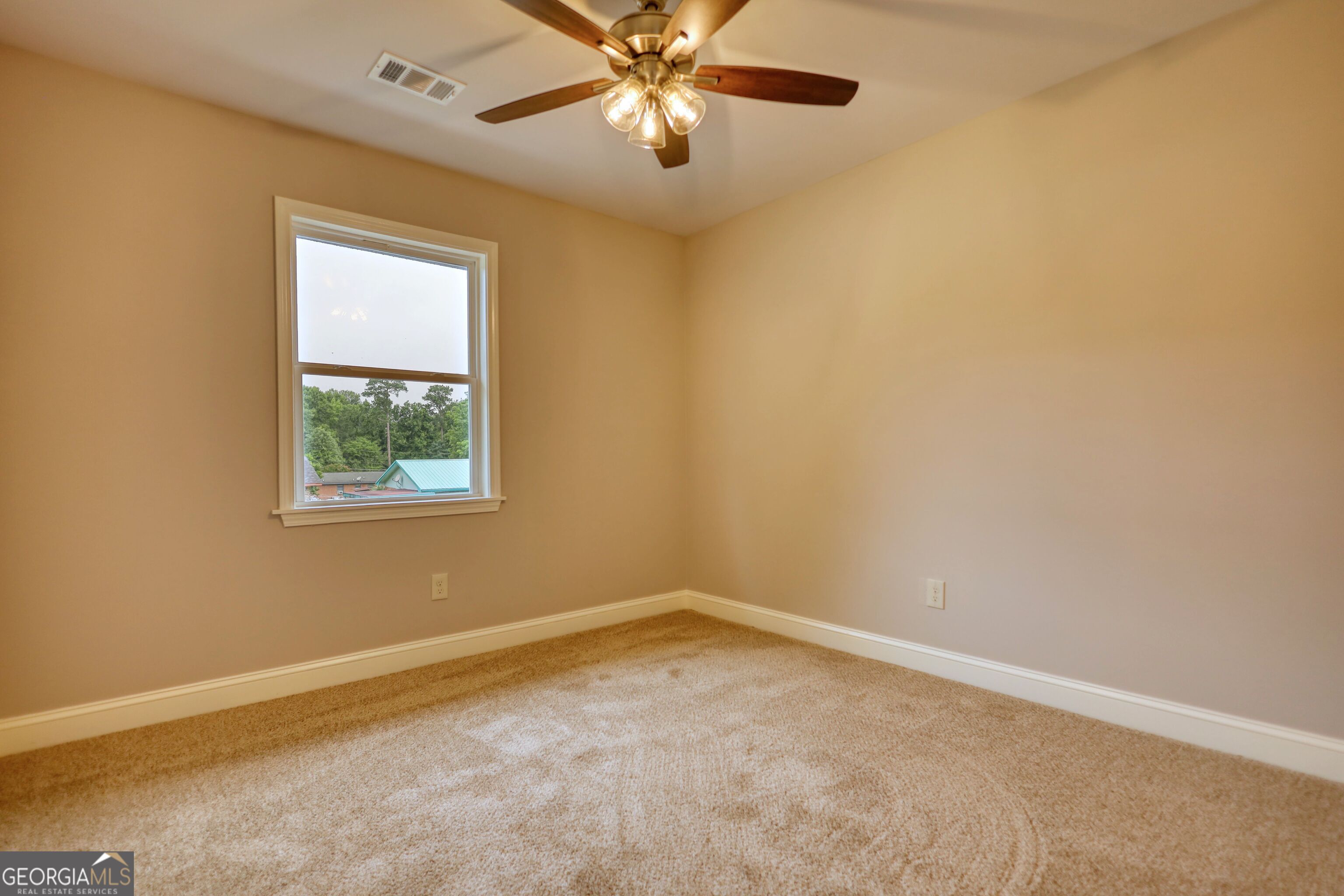 855 Meadow Ridge Drive Madison, GA 30650 - Photo 26 of 41 an empty room with a window and a fan