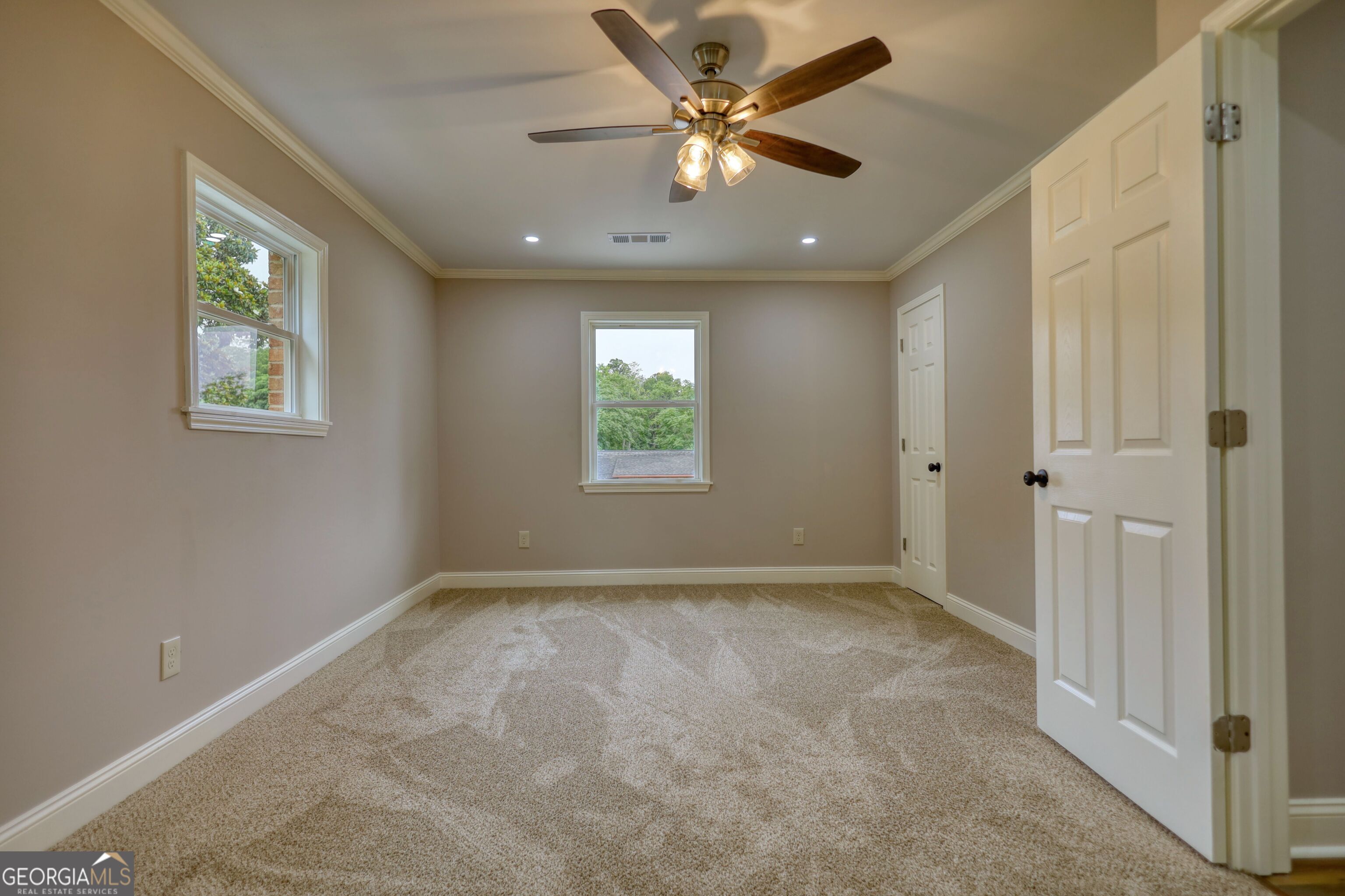 855 Meadow Ridge Drive Madison, GA 30650 - Photo 31 of 41 an empty room with windows and fan