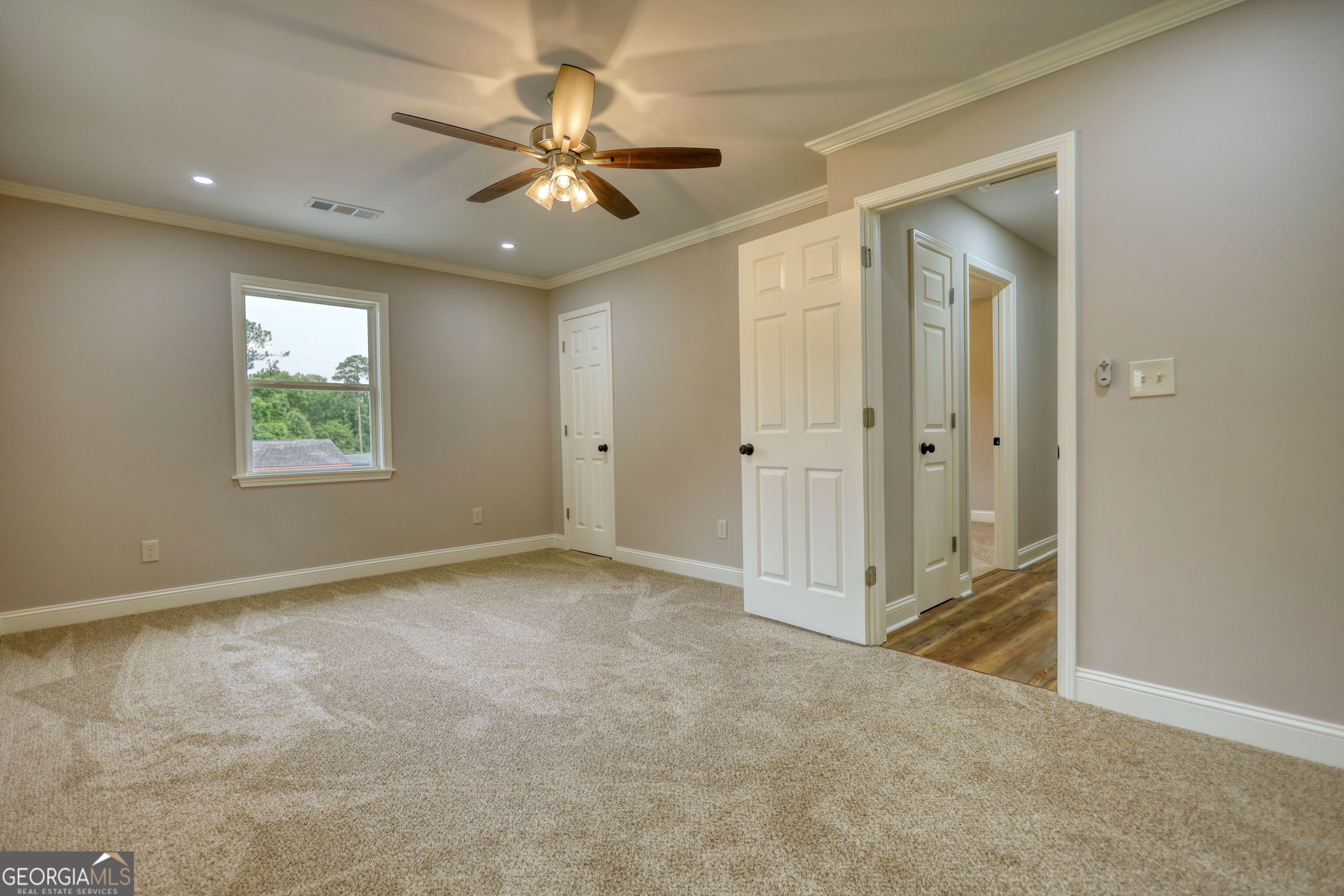 855 Meadow Ridge Drive Madison, GA 30650 - Photo 32 of 41 an empty room with fan and windows