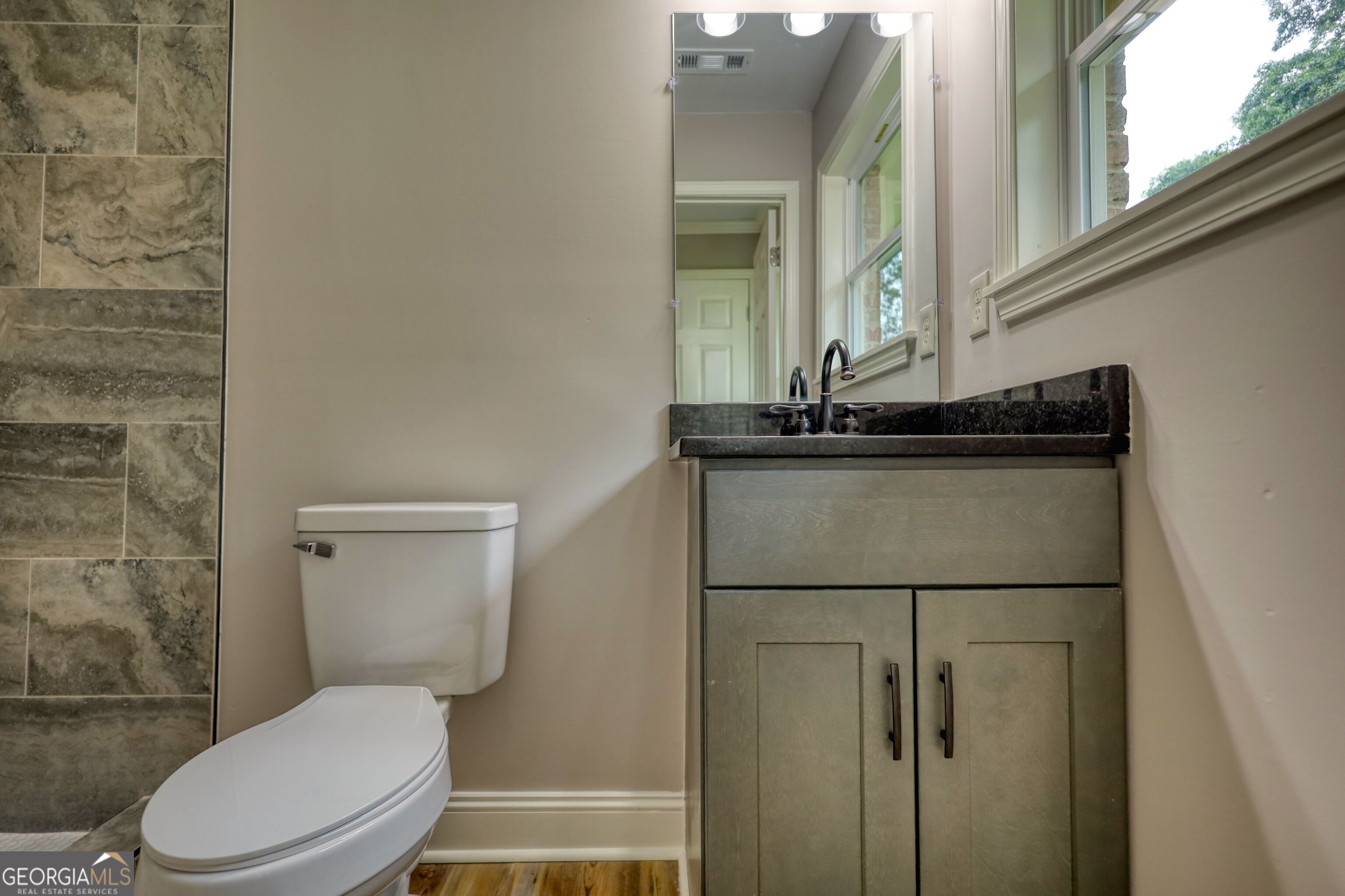 855 Meadow Ridge Drive Madison, GA 30650 - Photo 33 of 41 a white toilet sitting next to a bathroom sink