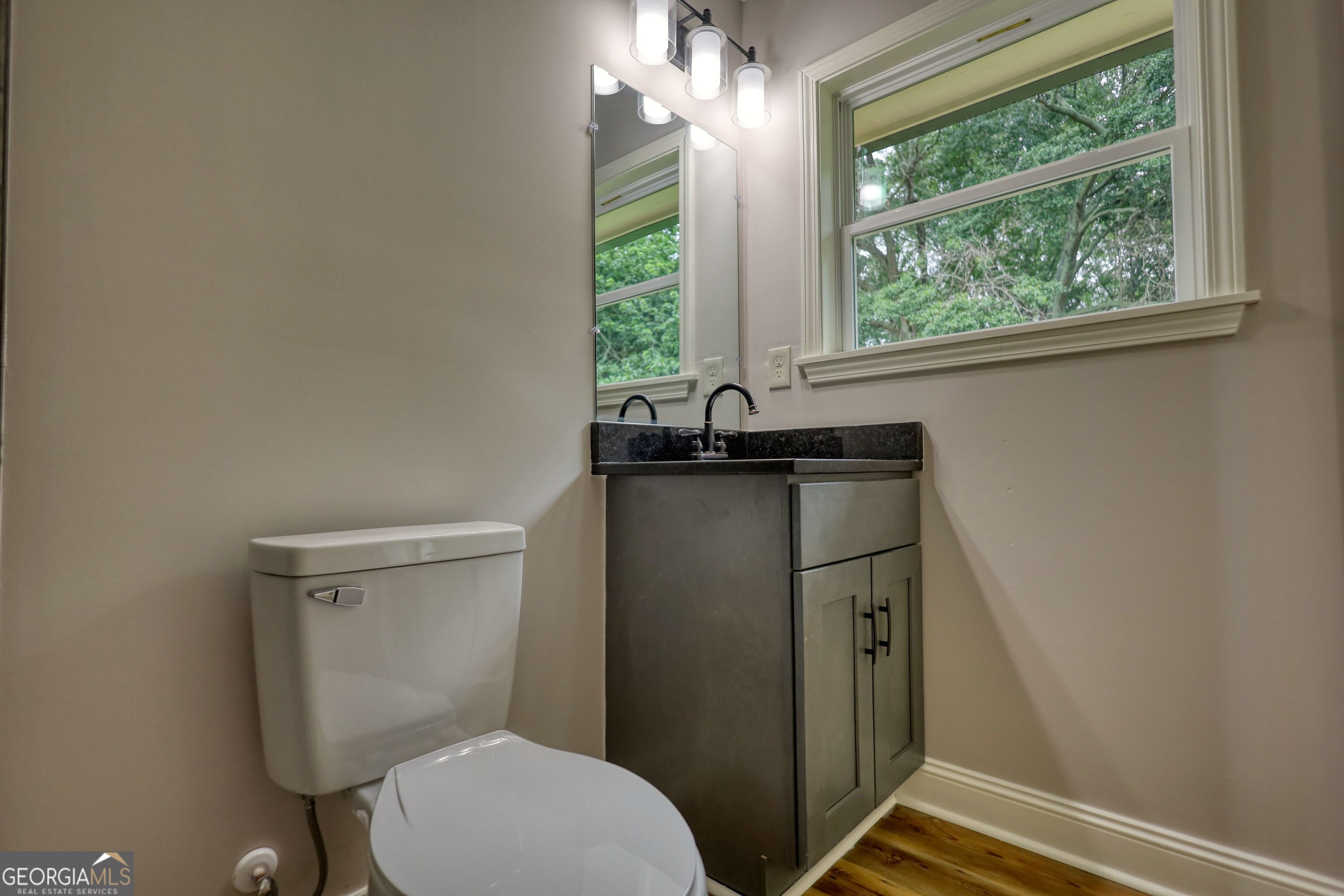 855 Meadow Ridge Drive Madison, GA 30650 - Photo 34 of 41 a bathroom with a granite countertop toilet and a sink