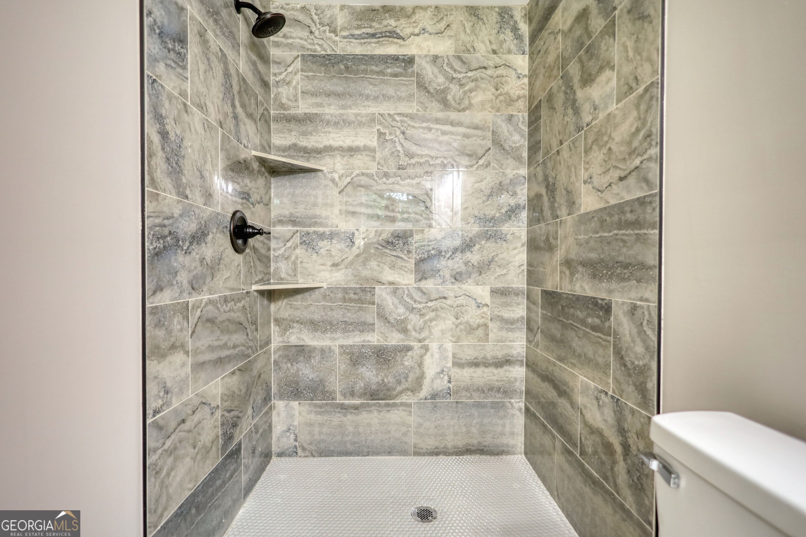 855 Meadow Ridge Drive Madison, GA 30650 - Photo 36 of 41 a bathroom with a shower and a toilet