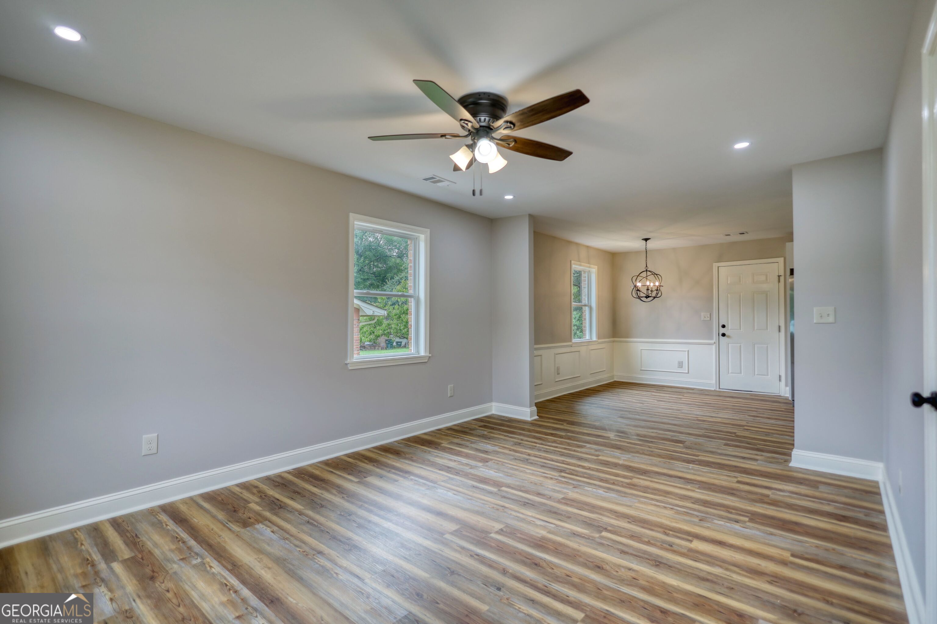 855 Meadow Ridge Drive Madison, GA 30650 - Photo 6 of 41 wooden floor in an empty room with a window