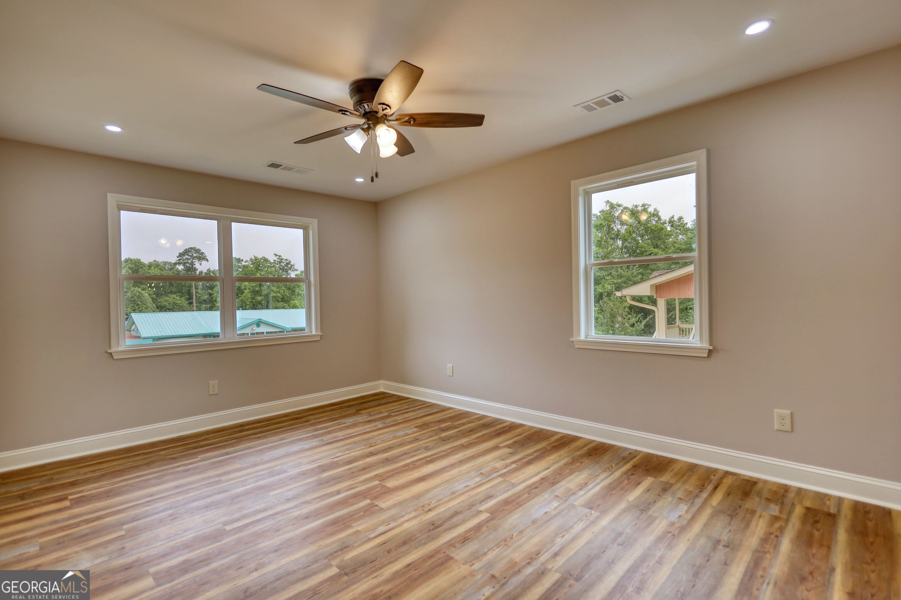 855 Meadow Ridge Drive Madison, GA 30650 - Photo 7 of 41 a view of an empty room with wooden floor and a window