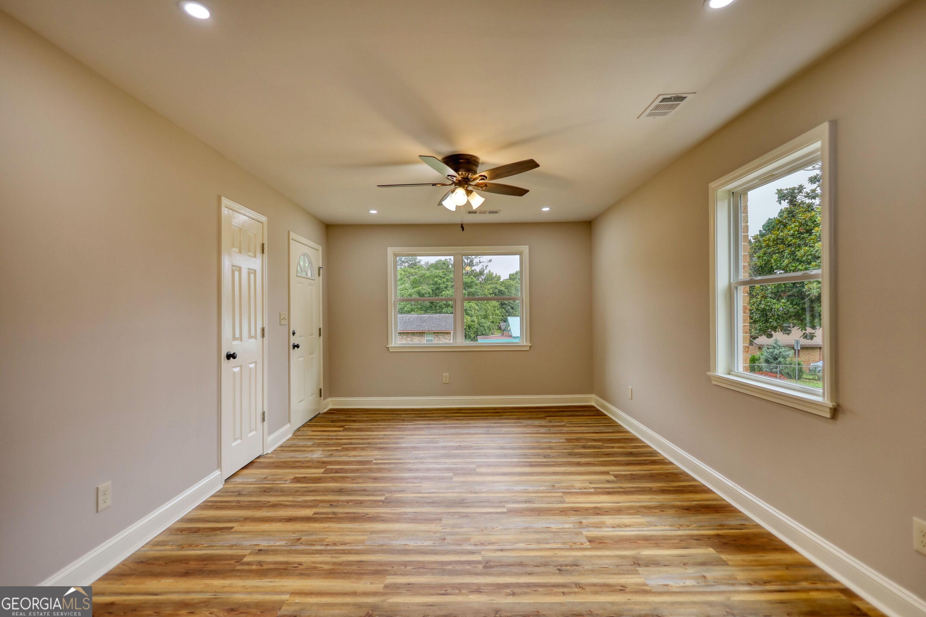 855 Meadow Ridge Drive Madison, GA 30650 - Photo 8 of 41 wooden floor in an empty room with a window