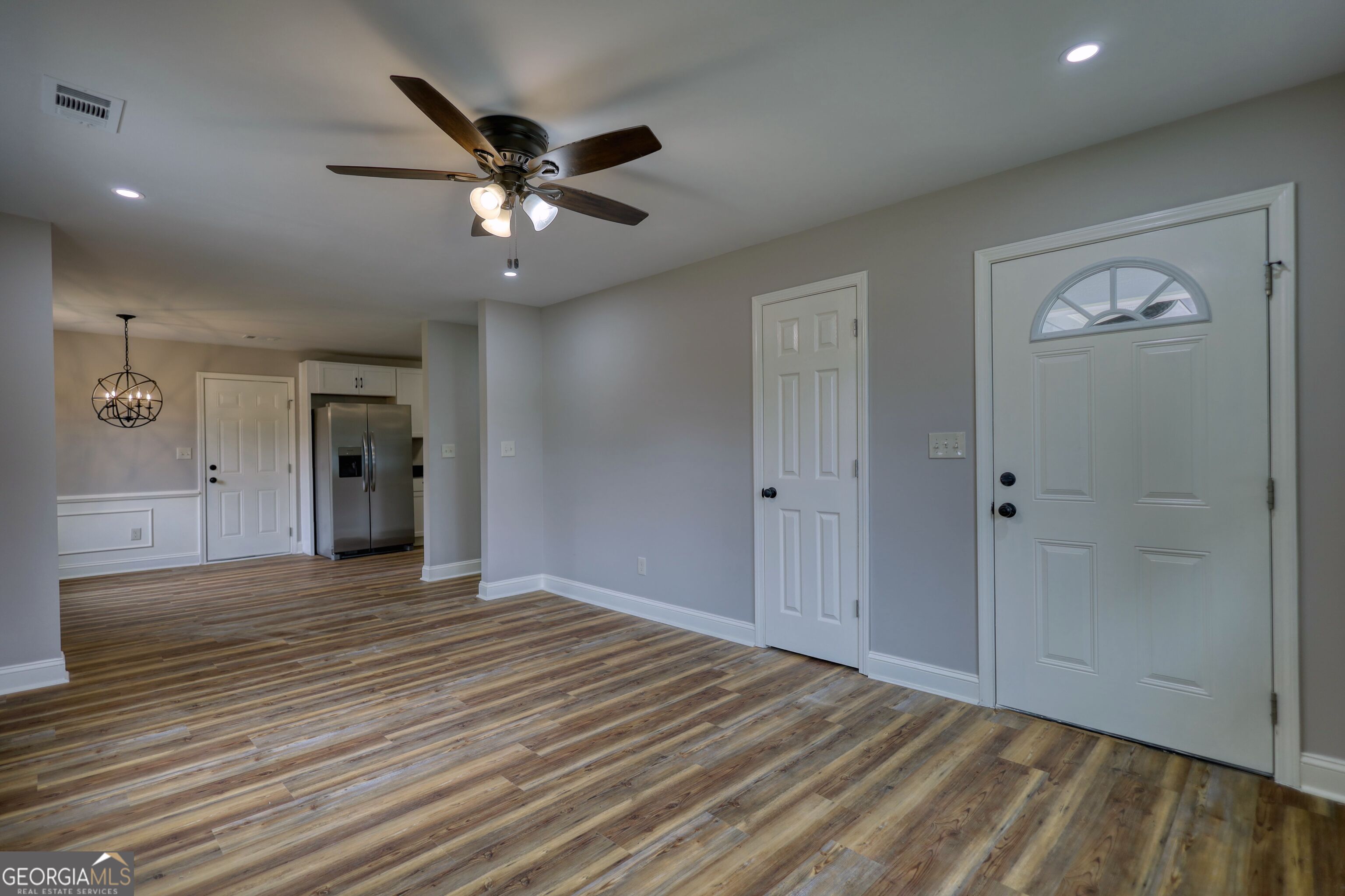855 Meadow Ridge Drive Madison, GA 30650 - Photo 10 of 41 a view of an empty room with a ceiling fan