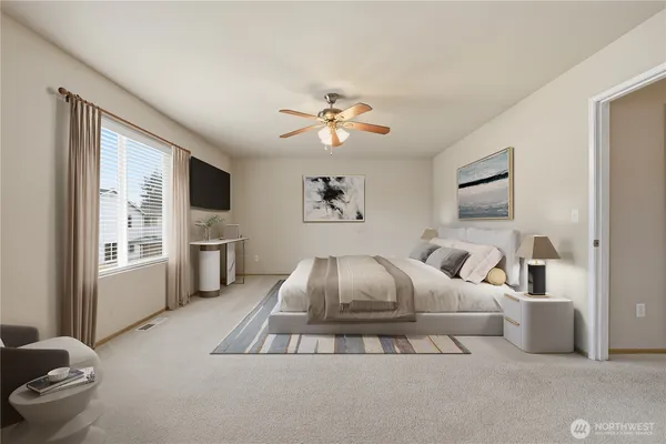 a spacious bedroom with a large bed and a flat screen tv