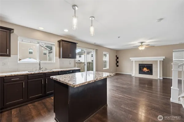 a large kitchen with granite countertop center island and a sink