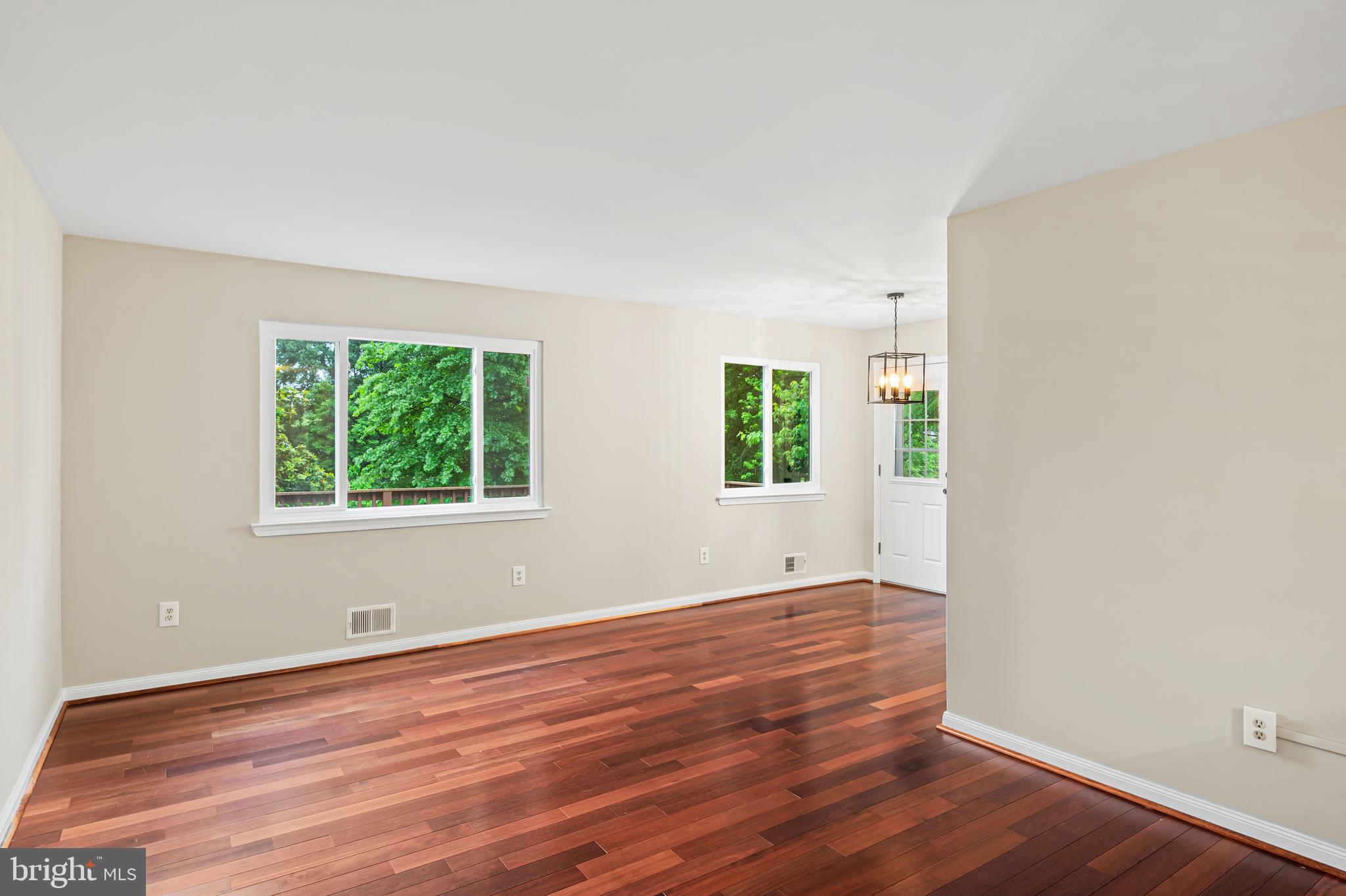 6411 Darwin Road Laurel, MD 20707 - Photo 10 of 41 an empty room with wooden floor and windows
