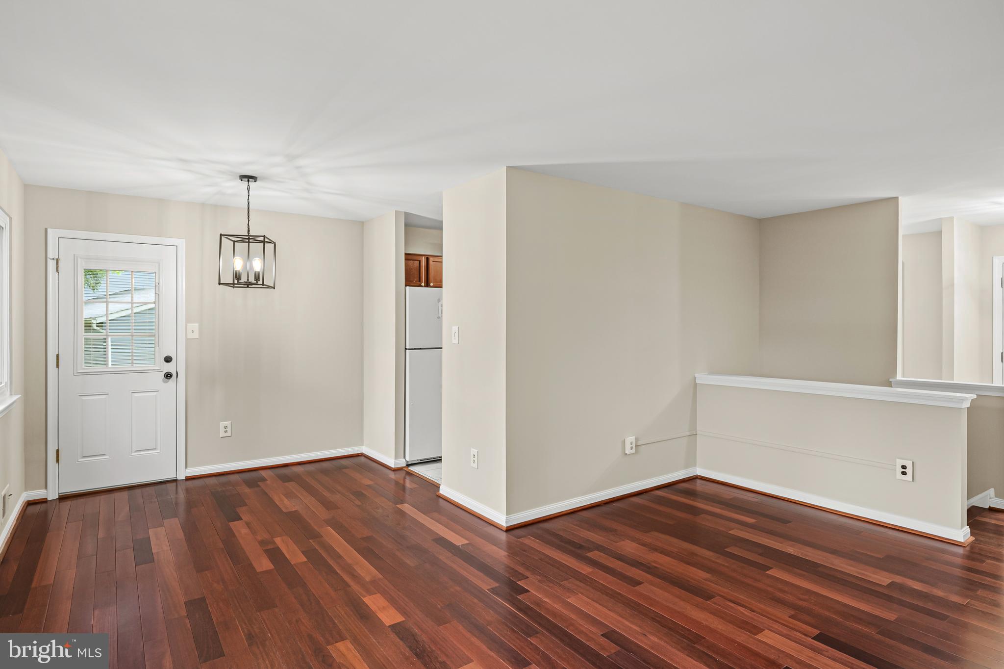 6411 Darwin Road Laurel, MD 20707 - Photo 11 of 41 an empty room with wooden floor and windows