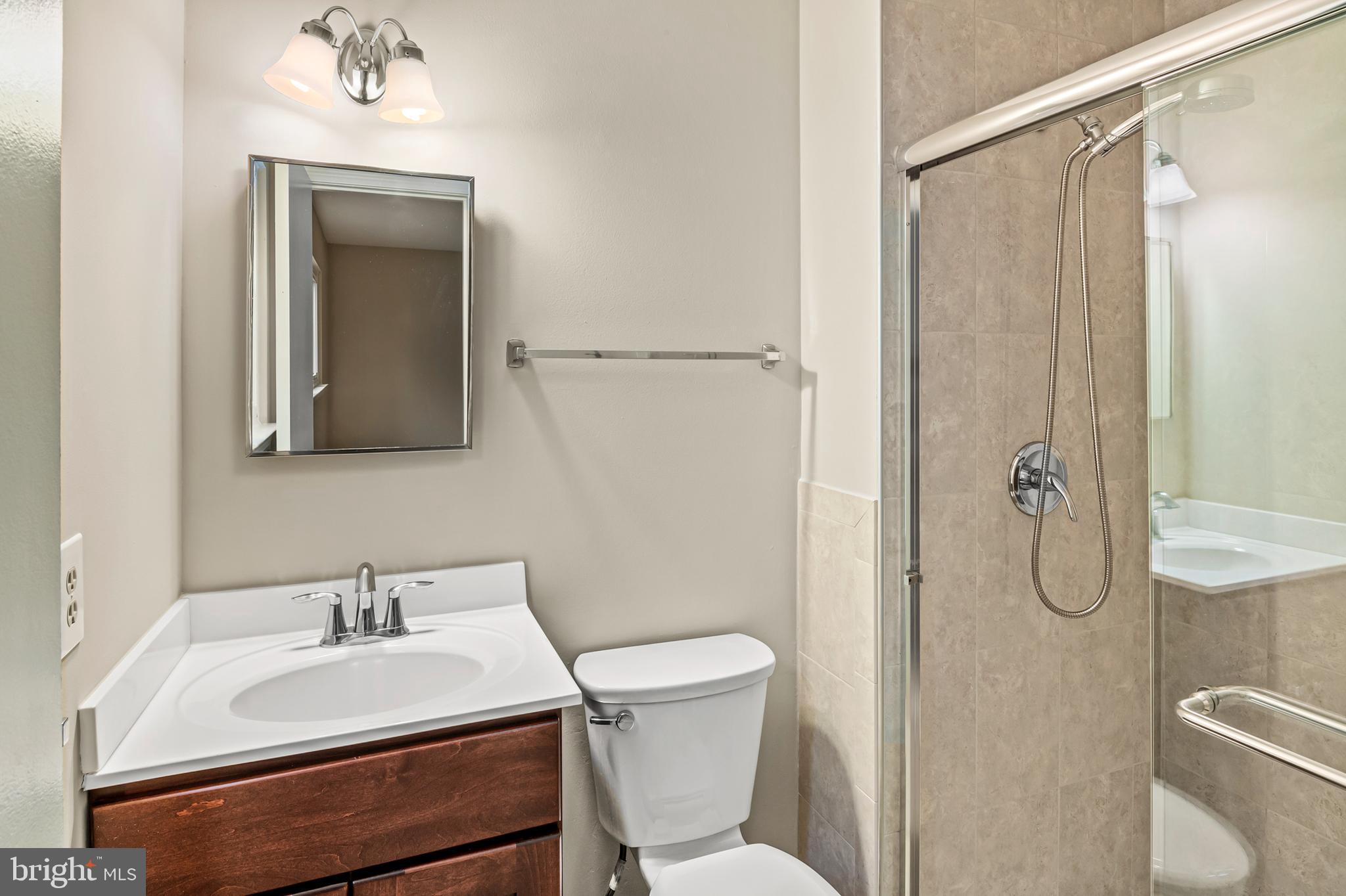 6411 Darwin Road Laurel, MD 20707 - Photo 17 of 41 a bathroom with a sink toilet and shower
