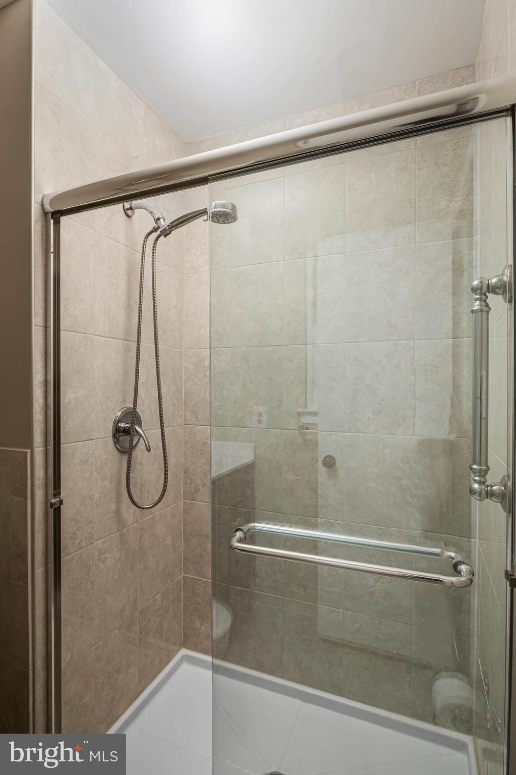 6411 Darwin Road Laurel, MD 20707 - Photo 18 of 41 a bathroom with a shower and a glass door