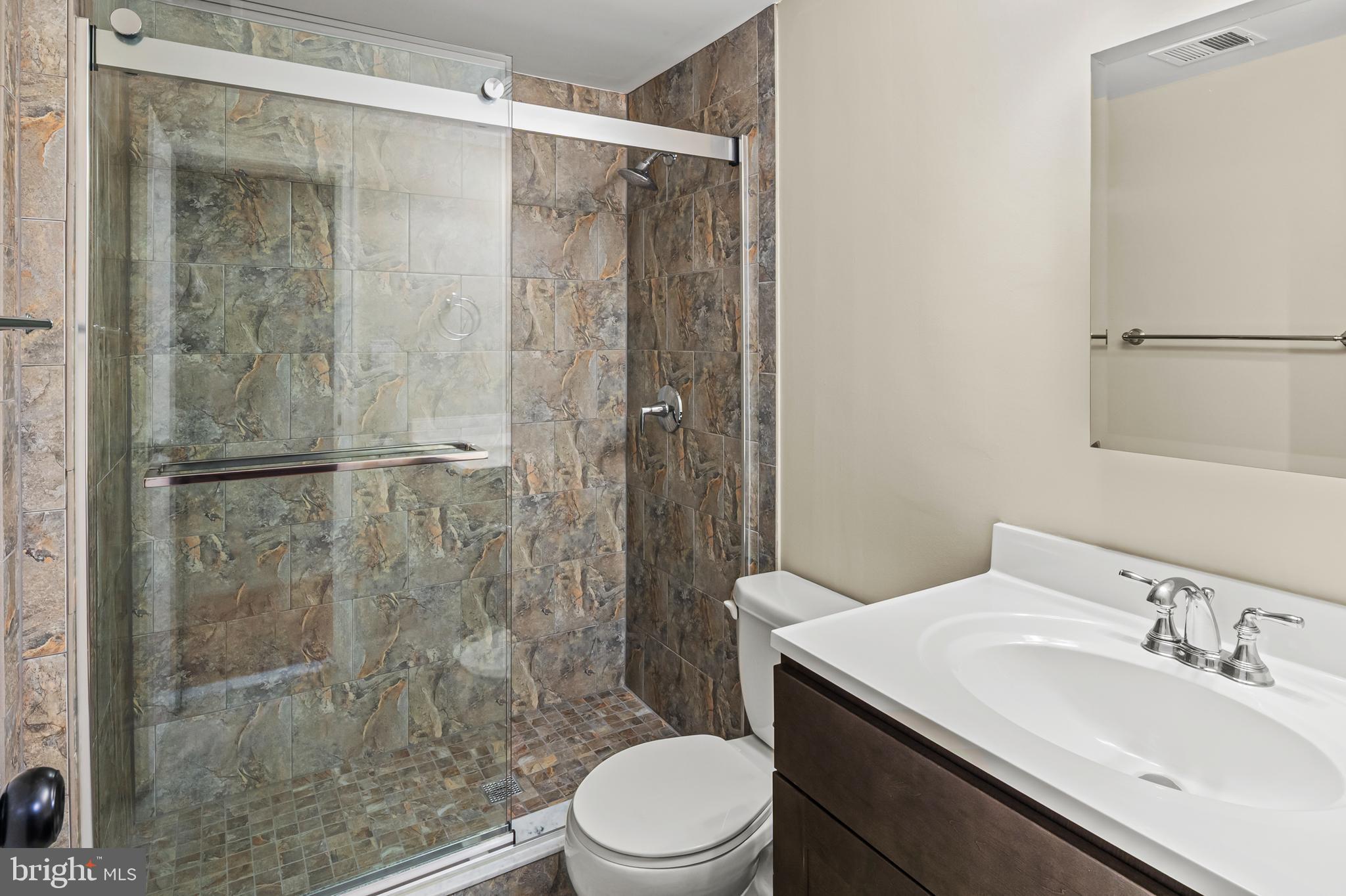 6411 Darwin Road Laurel, MD 20707 - Photo 27 of 41 a bathroom with a sink toilet and shower