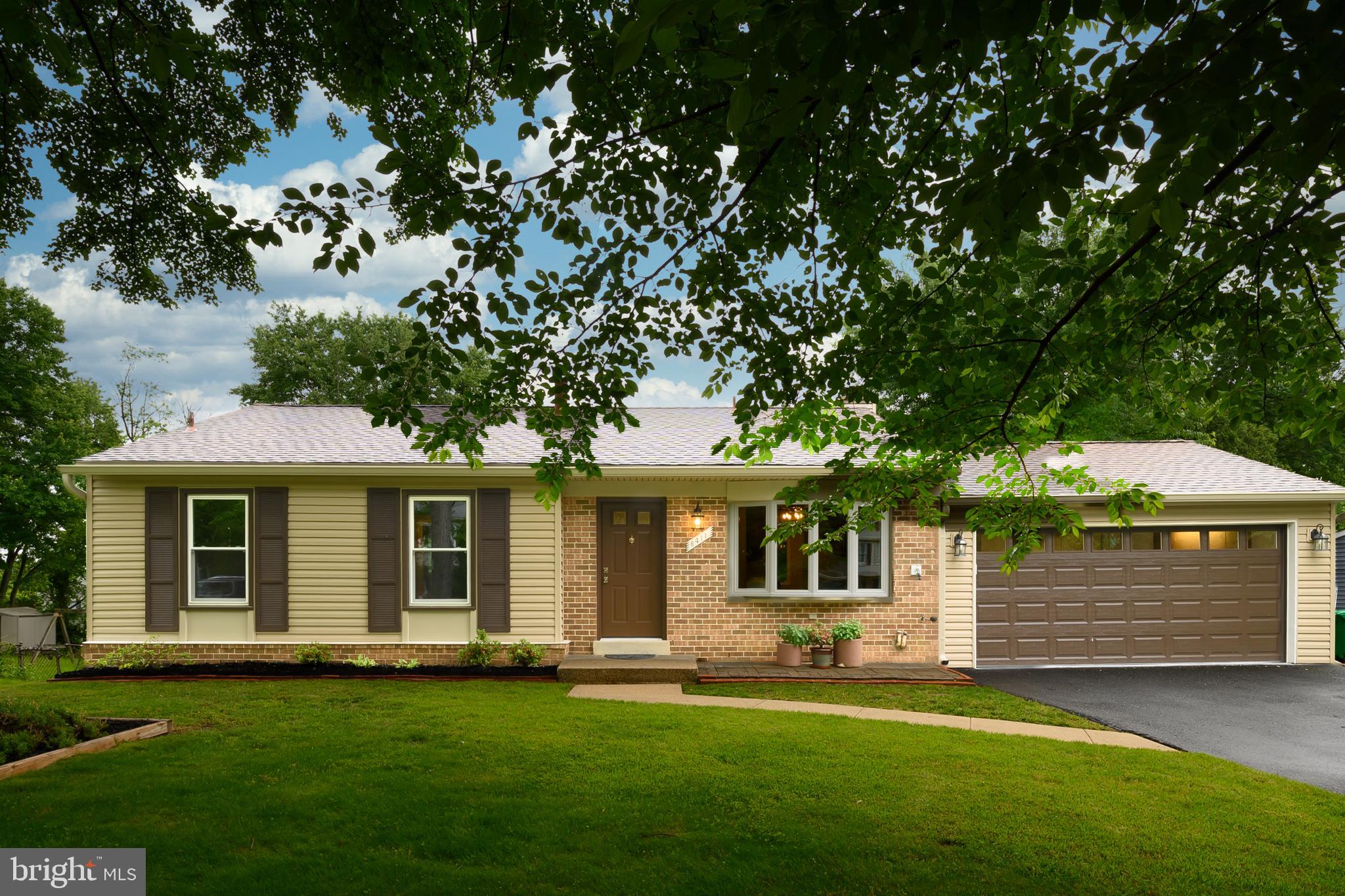 6411 Darwin Road Laurel, MD 20707 - Photo 3 of 41 a front view of a house with a garden