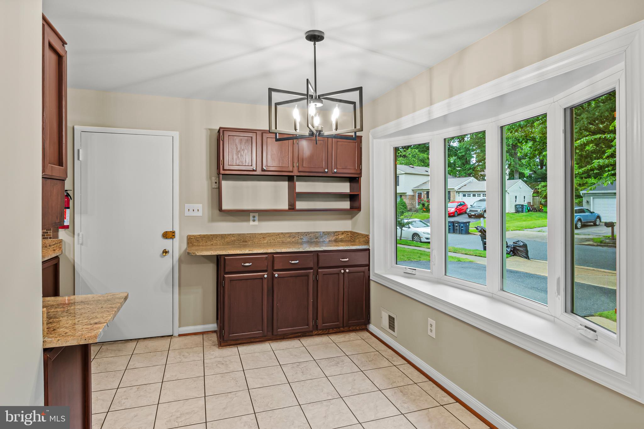 6411 Darwin Road Laurel, MD 20707 - Photo 7 of 41 a kitchen with stainless steel appliances granite countertop a stove and a wooden cabinets