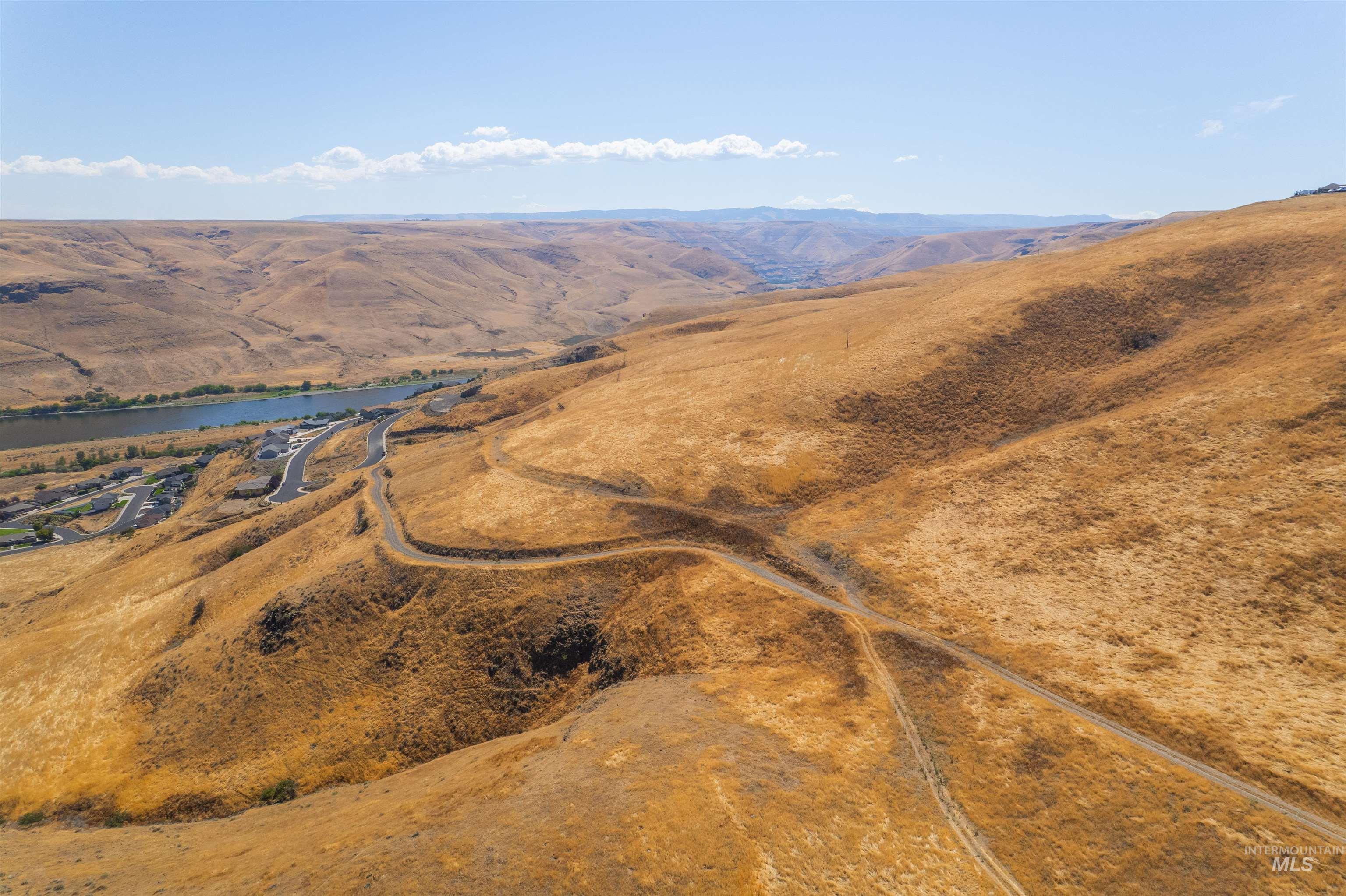 1550 Perro Pointe Road Asotin, WA 99402 - Photo 24 of 50 Aerial view of property and surrounding area featuring a water and mountain view and rural landscape
