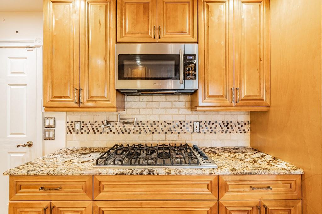 2650 Northeast 52nd Street Lighthouse Point, FL 33064 - Photo 14 of 35 a kitchen with a stove and a microwave