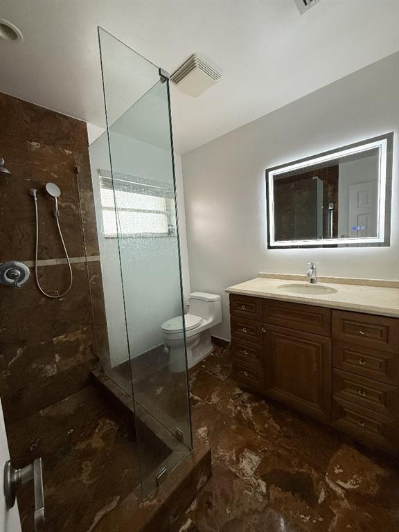 2650 Northeast 52nd Street Lighthouse Point, FL 33064 - Photo 20 of 35 a bathroom with a sink a toilet and shower