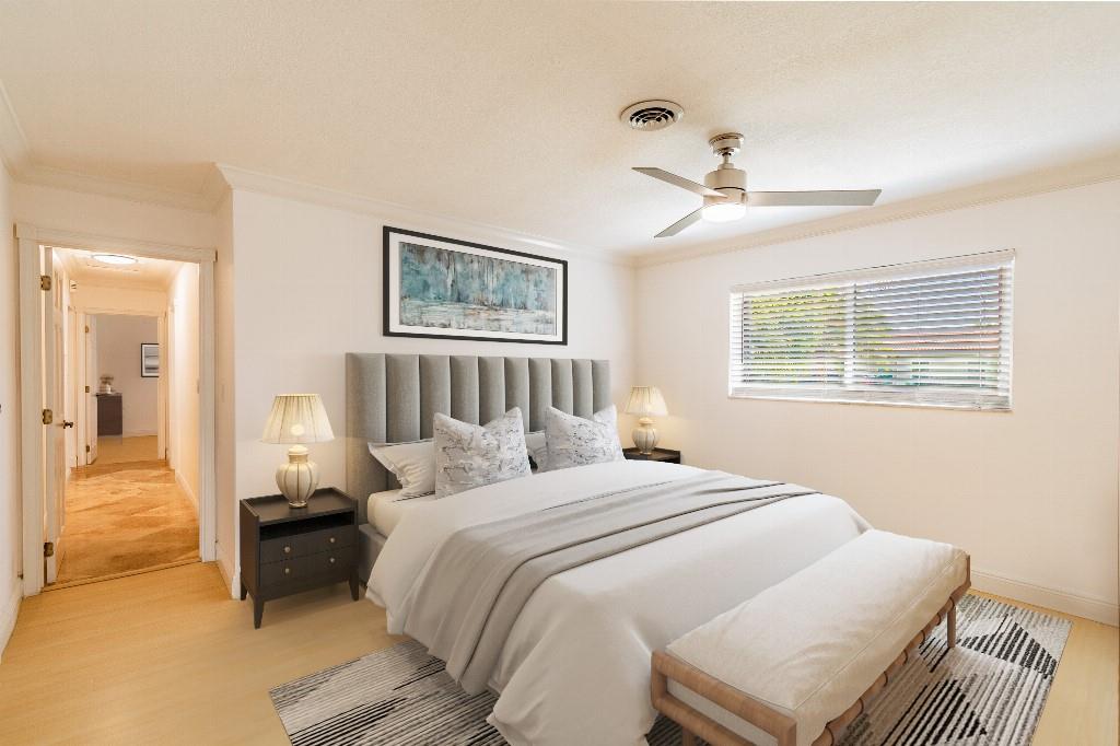 2650 Northeast 52nd Street Lighthouse Point, FL 33064 - Photo 4 of 35 a bedroom with a bed and a chandelier