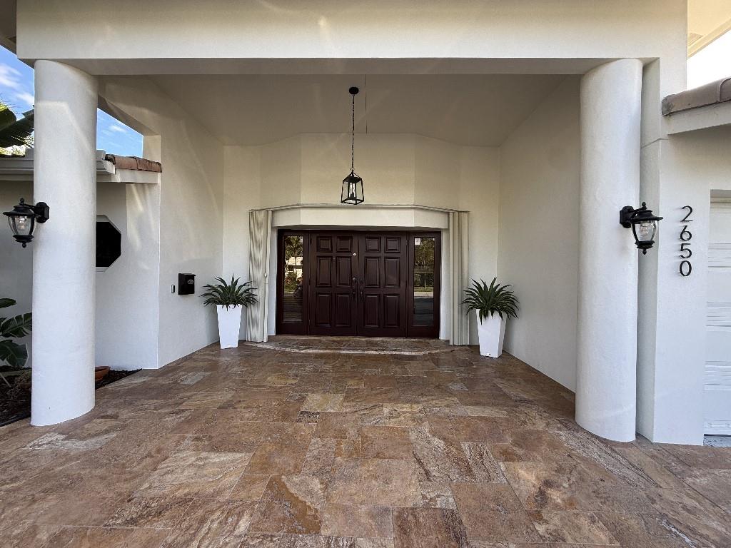 2650 Northeast 52nd Street Lighthouse Point, FL 33064 - Photo 9 of 35 a view of a hallway with a fireplace
