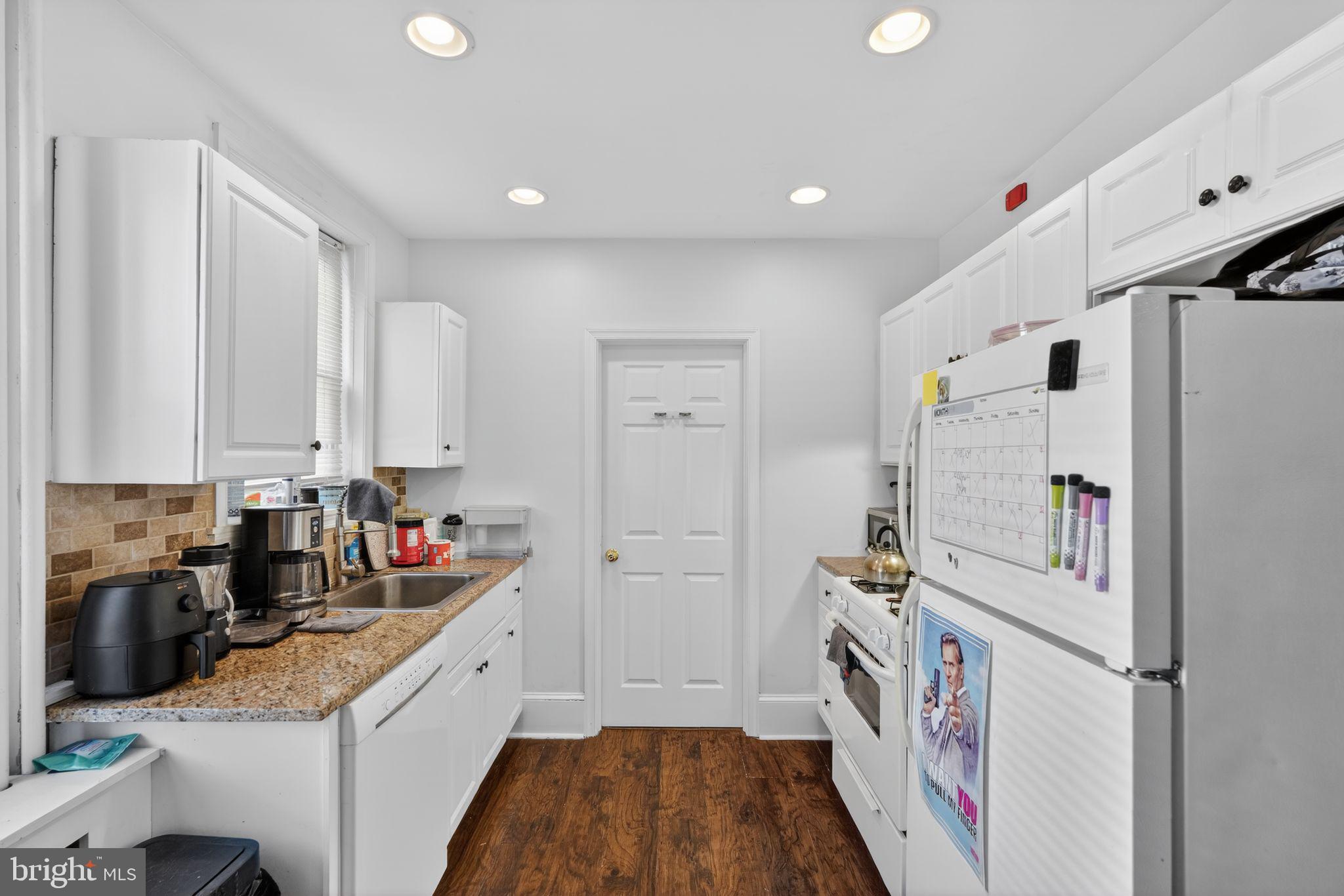 1229 South 6th Street Philadelphia, PA 19147 - Photo 17 of 36 a kitchen with white cabinets and refrigerator