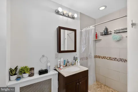 a bathroom with a sink a mirror and a shower