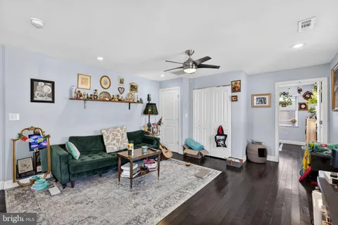 a living room with furniture and wooden floor