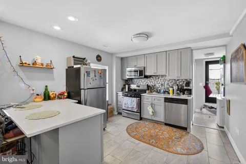 a kitchen with a refrigerator a stove a sink and a refrigerator