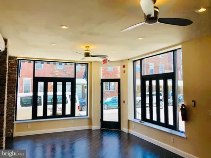 a hallway with wooden floor and windows