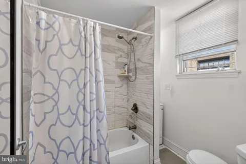 a bathroom with a shower curtain and a toilet